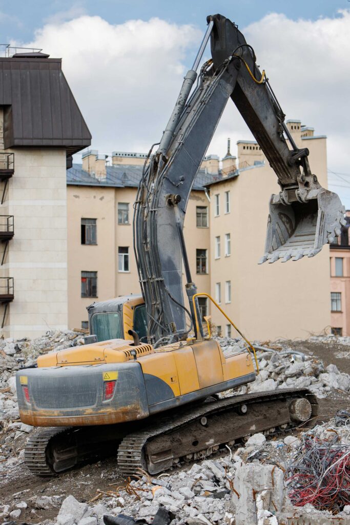 Dismantling of a building with hydraulic excavator.